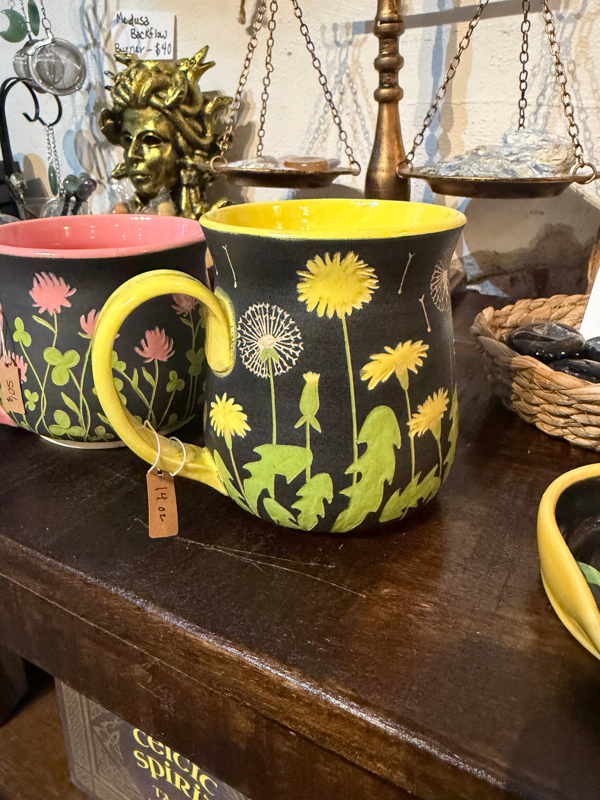 Kelly Gilleran Art black ceramic mug with yellow dandelions